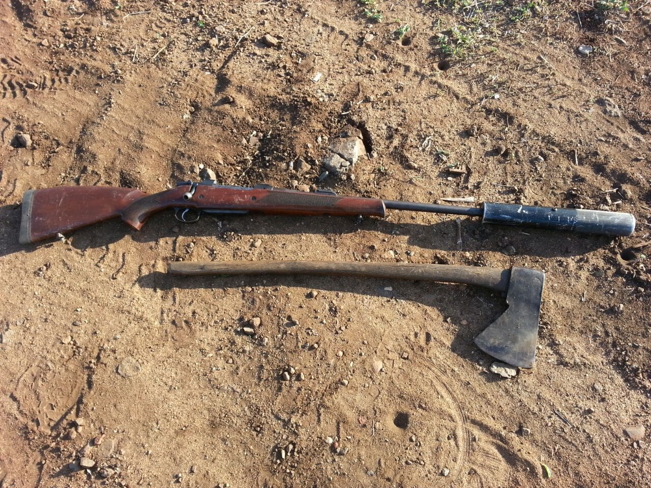 A high-caliber CZ hunting rifle and hatchet_ tools of the poacher's trade recovered from rhino crime scene - courtesy anti-poaching agency